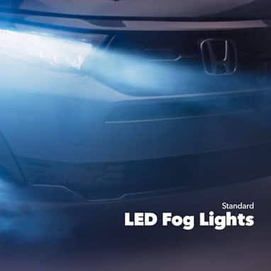 2027 Honda Odyssey Elite in Smoke Blue Pearl front studio showing standard LED fog lights and headlights (Minivan).